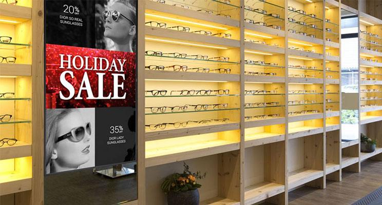 Digital signage promoting a holiday sales at an eyeglass retailer