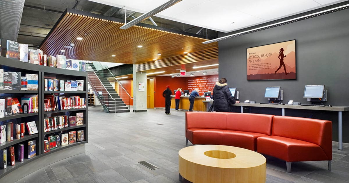 a library with digital signage and sofa set