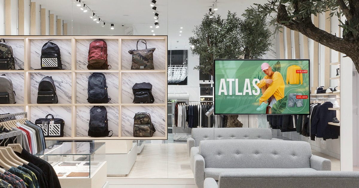 digital signage in a retail store with bags on the shelf